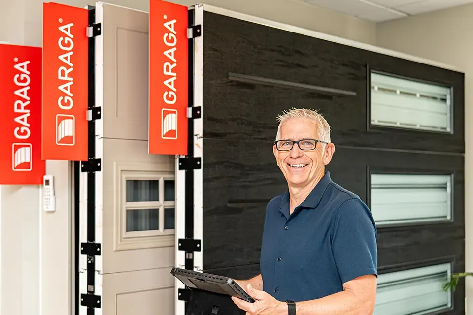 Guy with ipad in garage door showroom